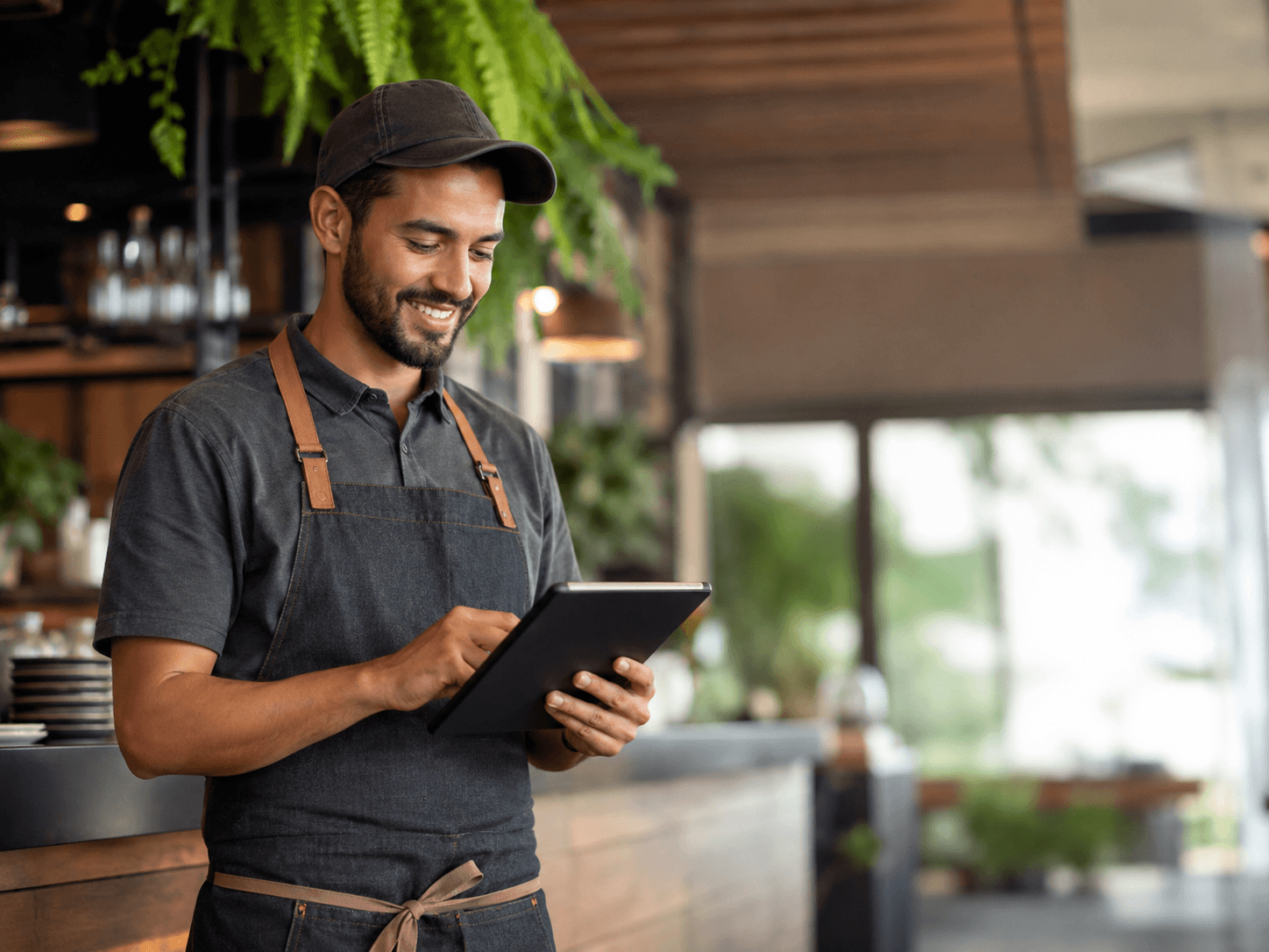 Restaurant staff member taking an order on a tablet
